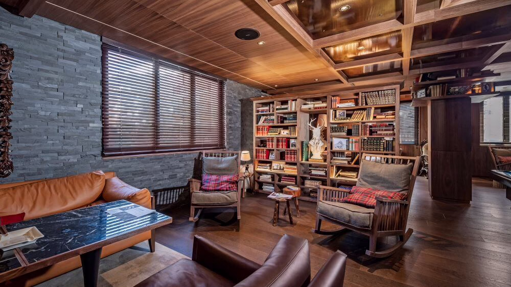 Lounge area with large bookshelf and heavy lounge furniture
