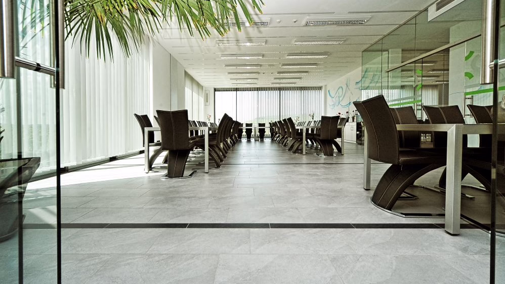 The finished lounge area with grey-black tiles and fine furniture